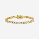 A gold tennis bracelet with a row of clear round-cut gemstones, displayed against a light gray background.