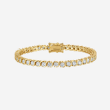 A gold tennis bracelet with a row of clear round-cut gemstones, displayed against a light gray background.