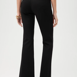 Black pants worn by a person on a white background