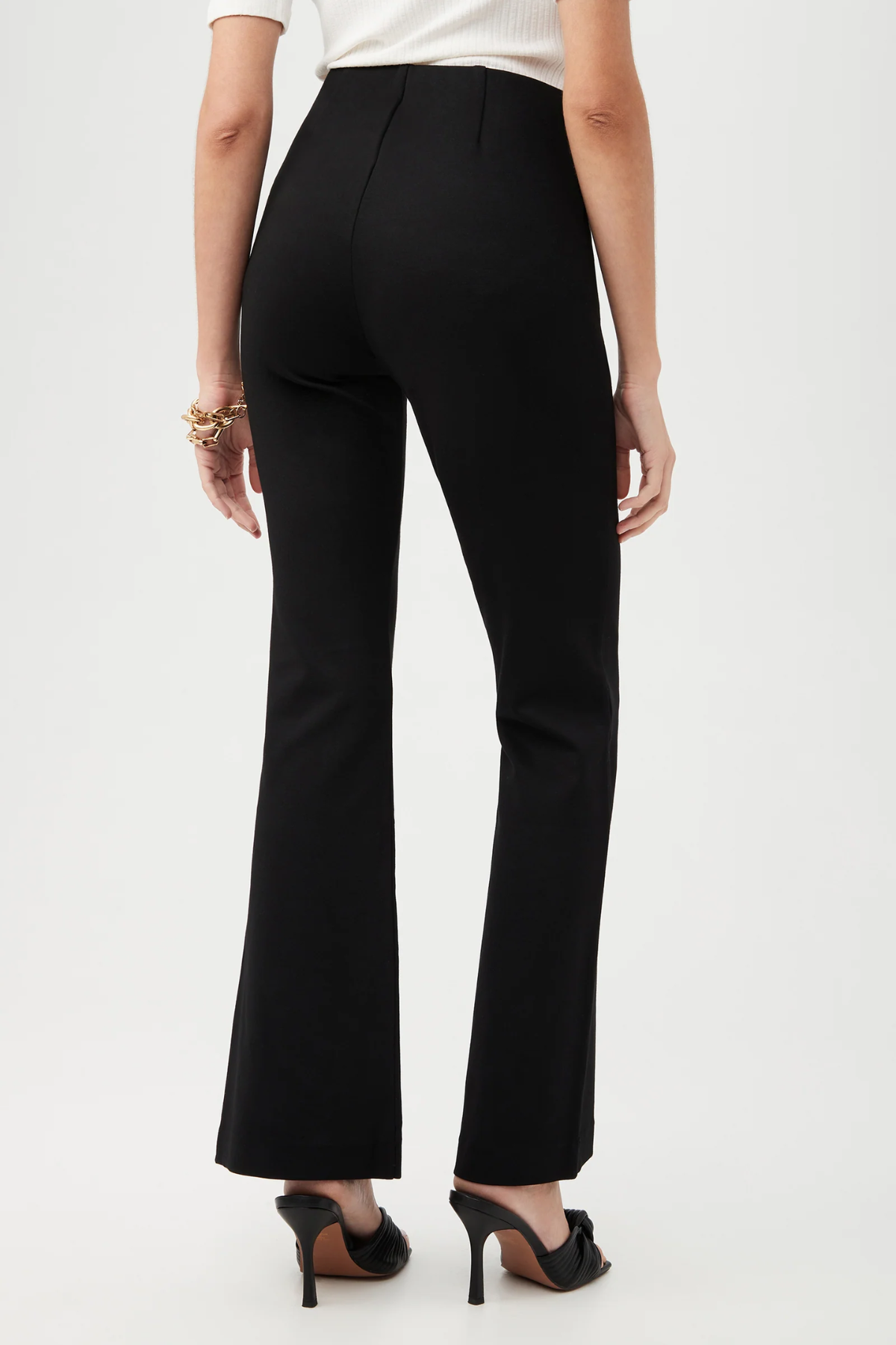 Black pants worn by a person on a white background