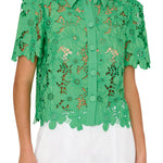 Green lace blouse worn by a person on a white background