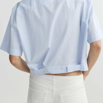 blue striped button up top worn by model against a white background