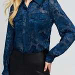 Women's floral burnout blouse featuring long sleeves, a semi-sheer finish, and feminine pattern.