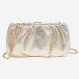 A metallic gold glitter clutch bag with a gathered, pleated texture and a gold chain strap, shown against a plain light gray background.