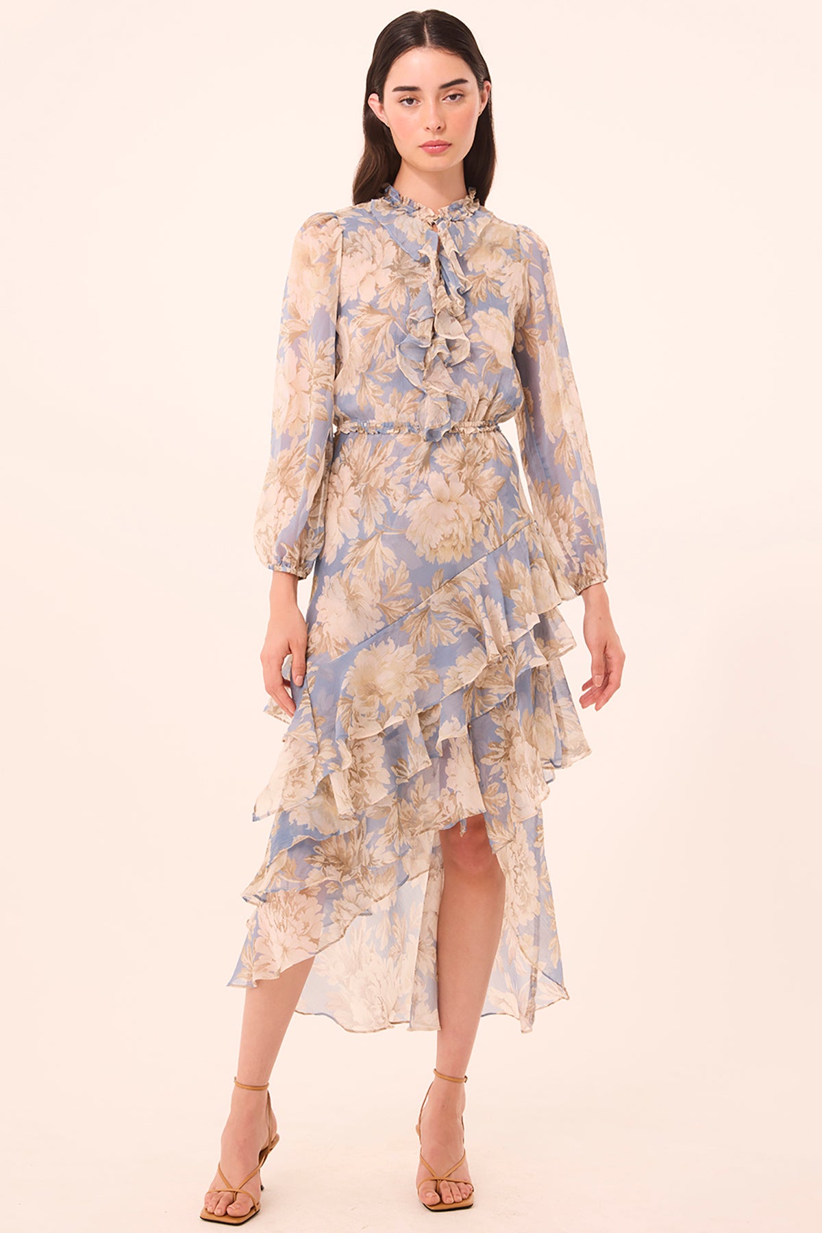 Woman wearing a floral dress on a beige background