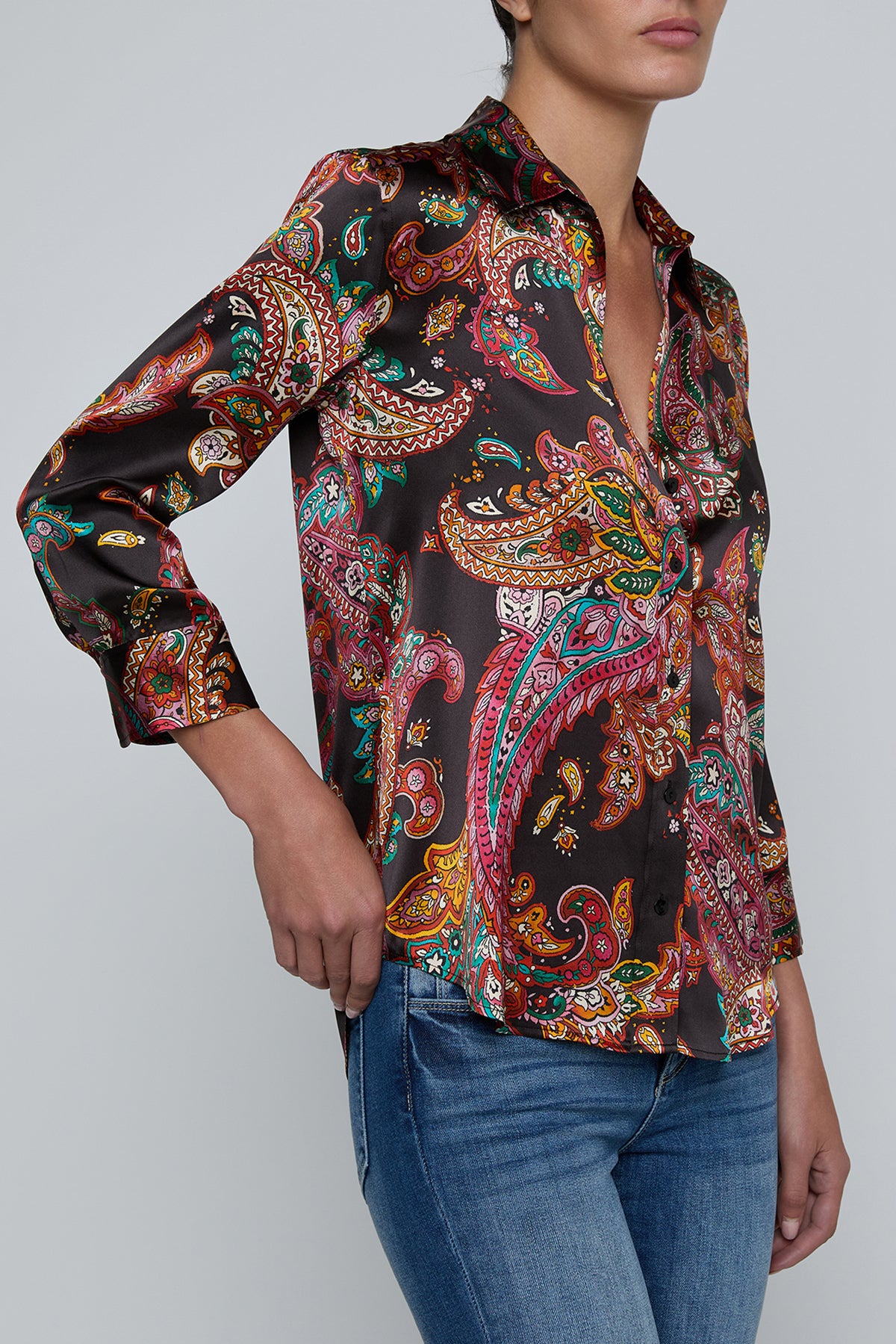 Person wearing l'agence  patterned shirt and jeans on a gray background