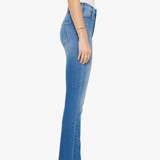 side view of woman in blue denim on white background 