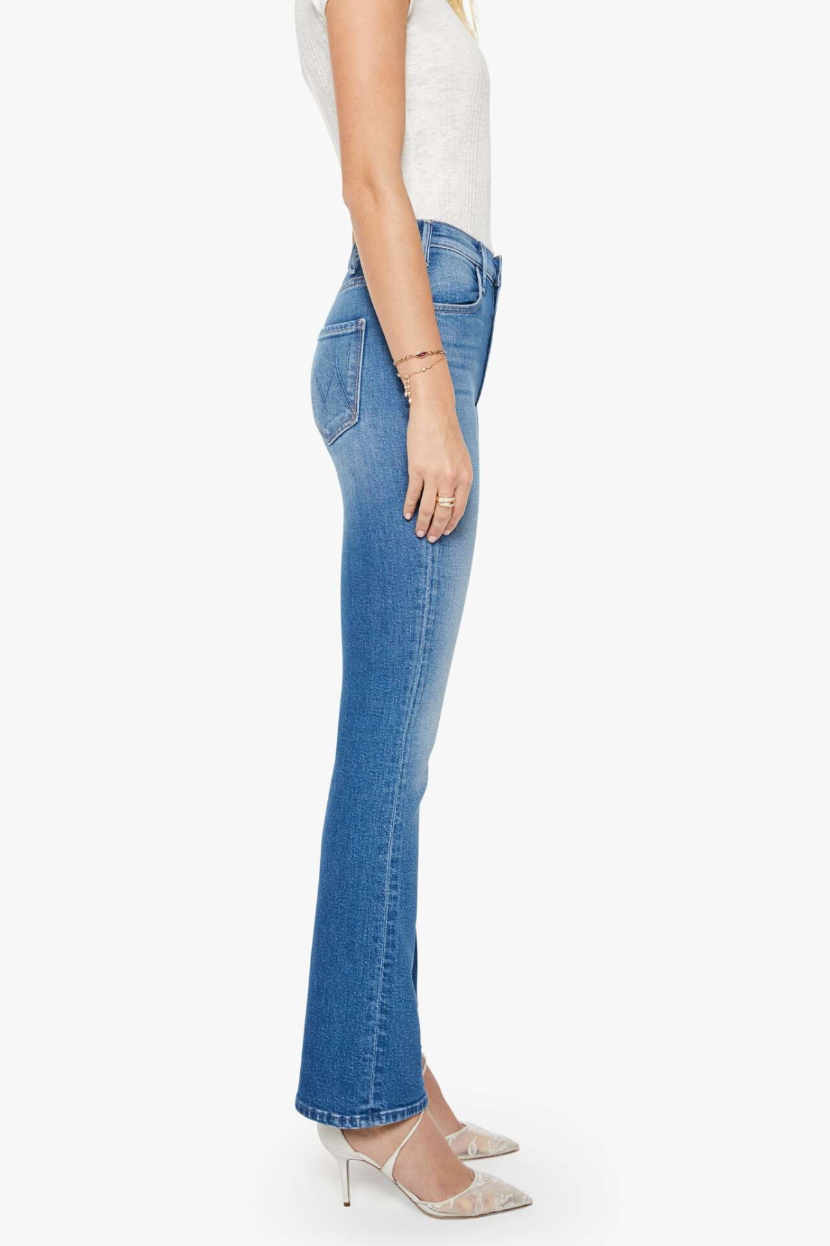side view of woman in blue denim on white background 