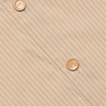 Beige fabric with a subtle pattern and two buttons on a diagonal line.