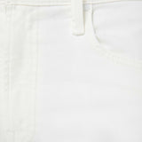 Close-up of white pants with a button on a light brown background