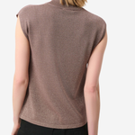 A woman shown from the back wearing a sleeveless mock neck knit top in a dusty mauve-brown color, paired with black trousers, against a light gray studio background.