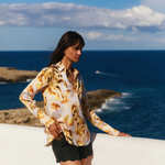 Woman standing by the ocean with a scenic view