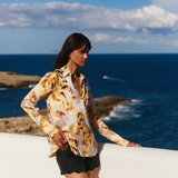Woman standing by the ocean with a scenic view