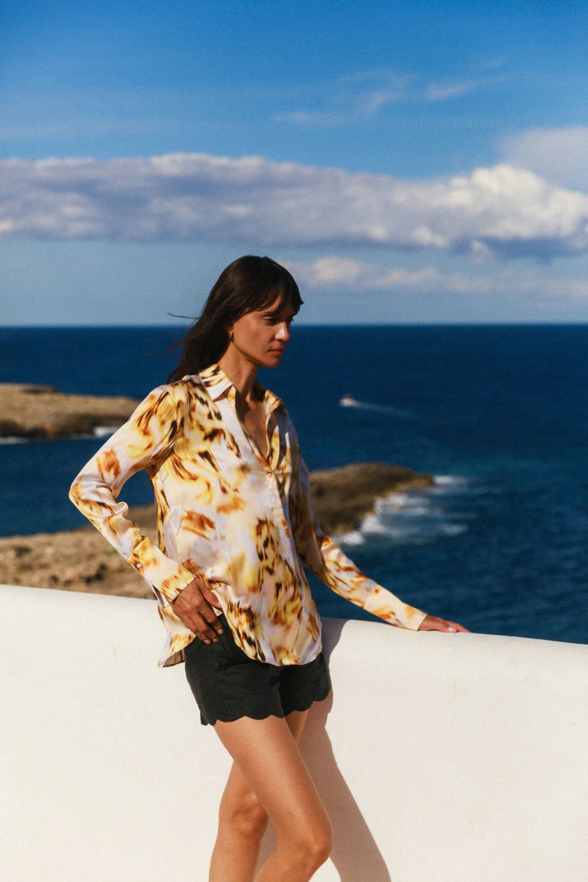 Woman standing by the ocean with a scenic view
