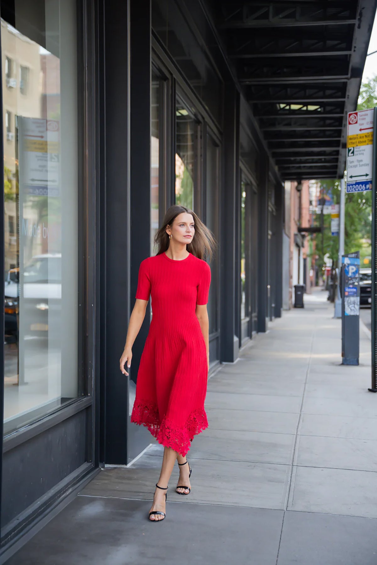Elegant red dress with a fluid silhouette, styled for an evening setting.