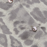 Long-sleeve blouse with a smooth, polished finish.