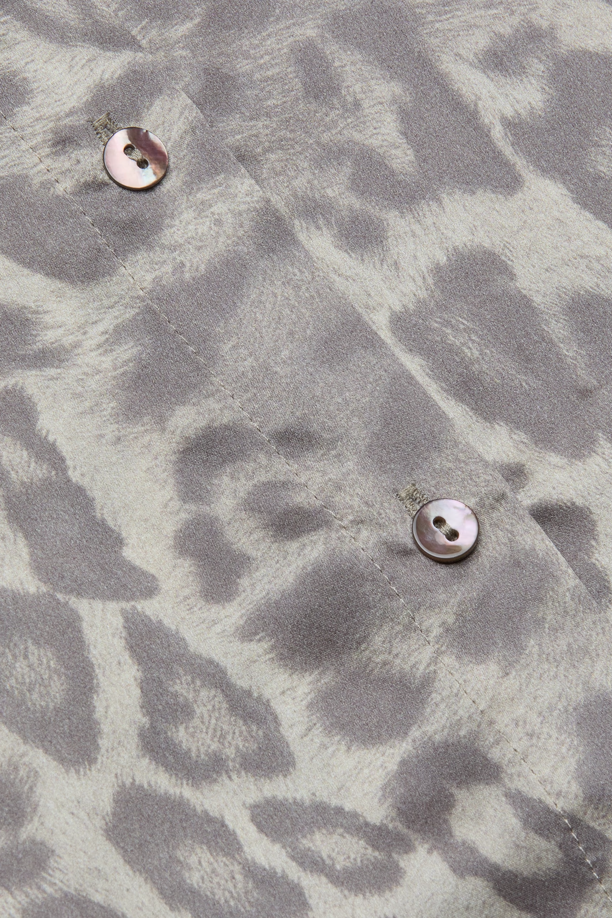 Long-sleeve blouse with a smooth, polished finish.