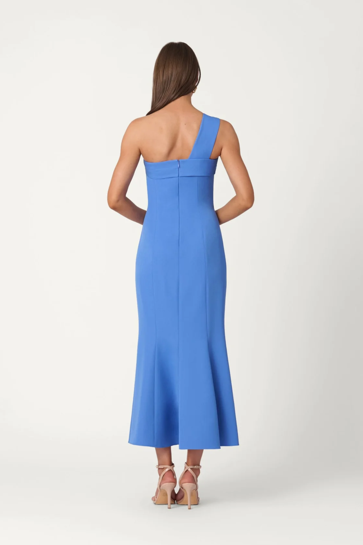 Woman wearing a blue one-shoulder dress on a white background