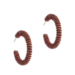 A pair of textured, spiral-shaped hoop earrings in a deep red and gold pattern, displayed on a clean white background.