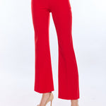 Red pants worn by a person on a white background