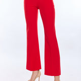 Red pants worn by a person on a white background