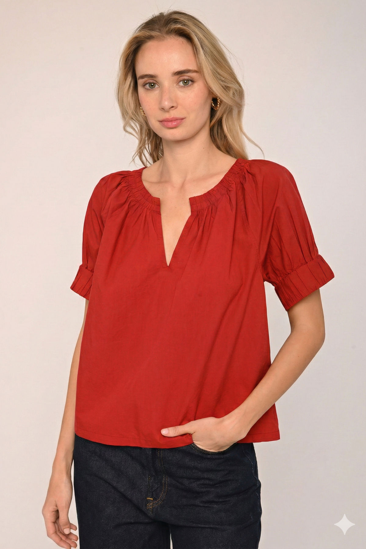 Woman wearing a red blouse with a plain background