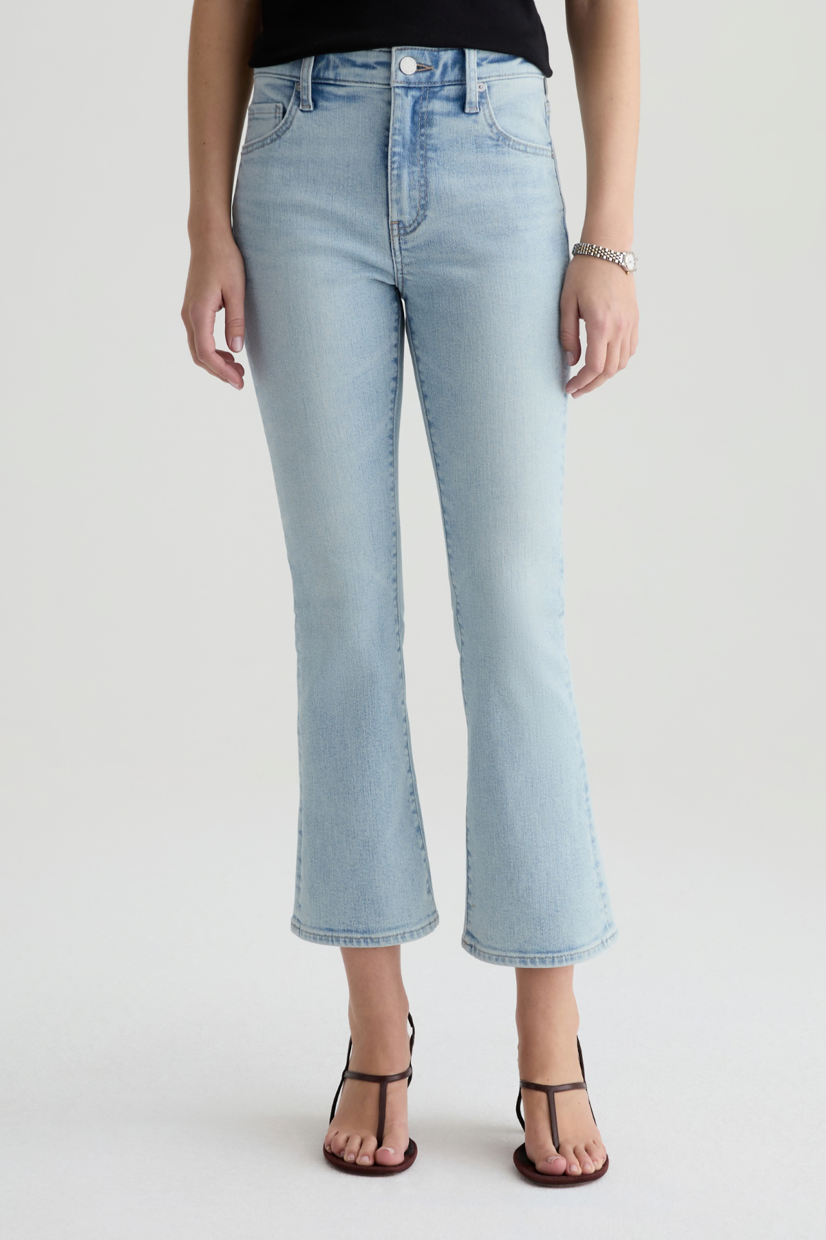 Light blue jeans worn by a person on a white background