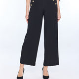 woman in black wide leg pants with gold buttons 