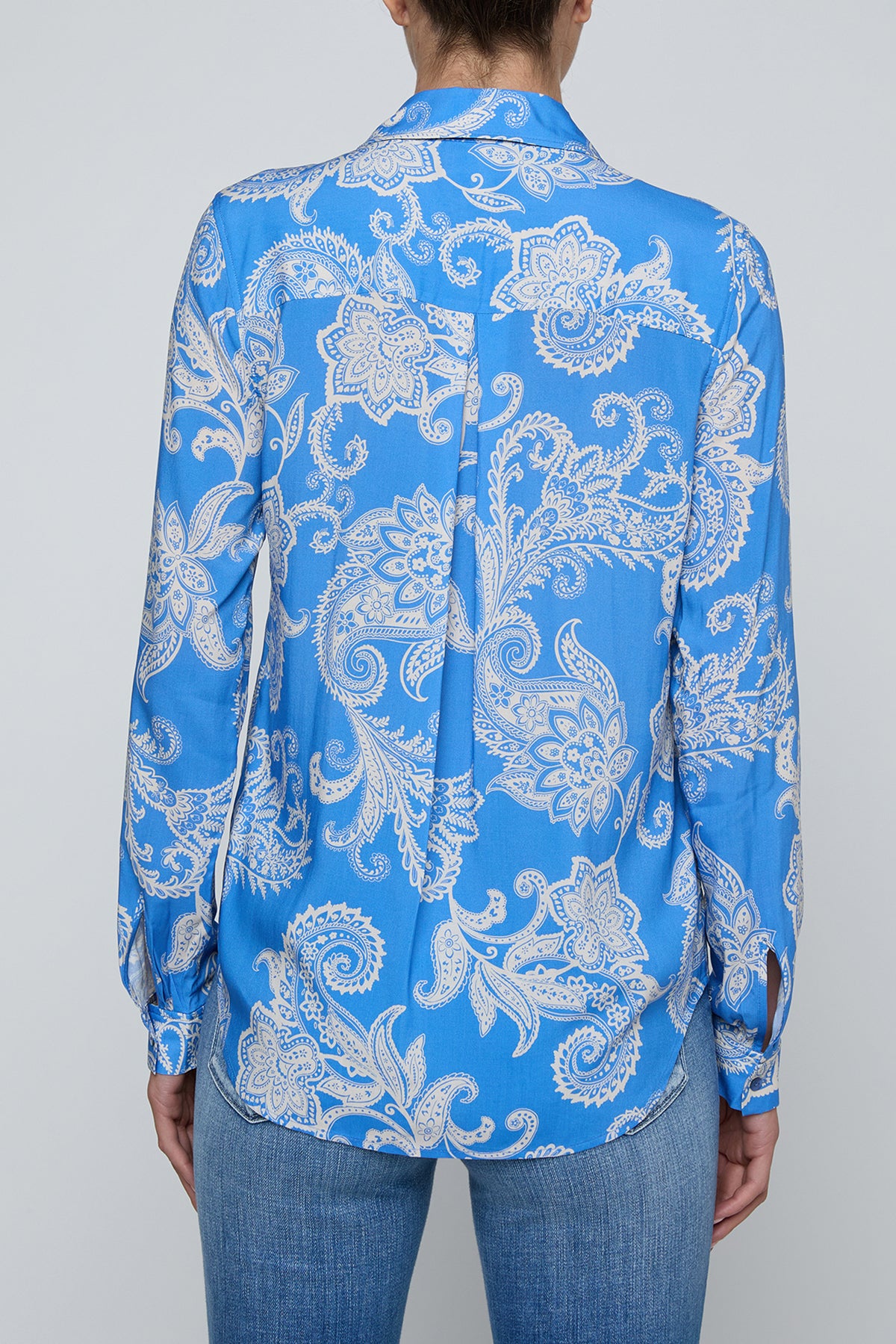 Long-sleeve blouse with fluid drape in a vibrant blue print.