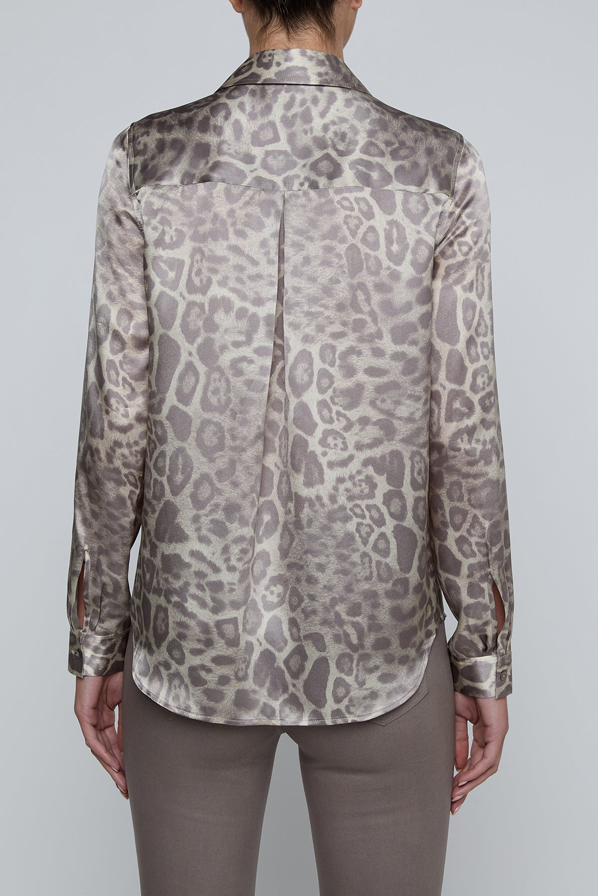 Long-sleeve blouse with a smooth, polished finish.