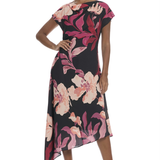 Model wearing a floral printed midi dress with cap sleeves, an asymmetrical hem, and a feminine flowing silhouette.