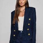 Navy structured blazer styled over a simple top.