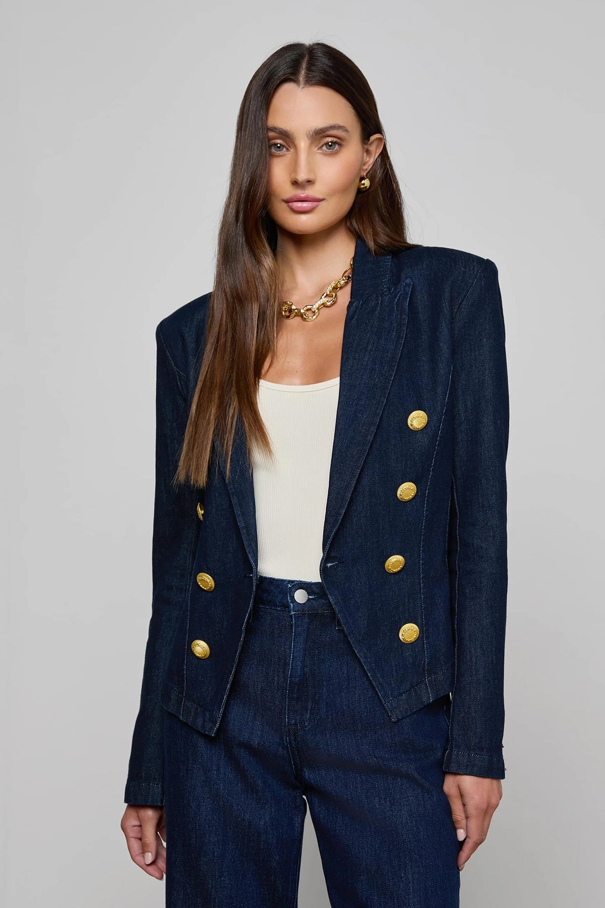 Navy structured blazer styled over a simple top.