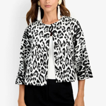 A woman modeling a black and white leopard print jacket with three-quarter sleeves, worn over a white ribbed top and black pants, against a plain white background.