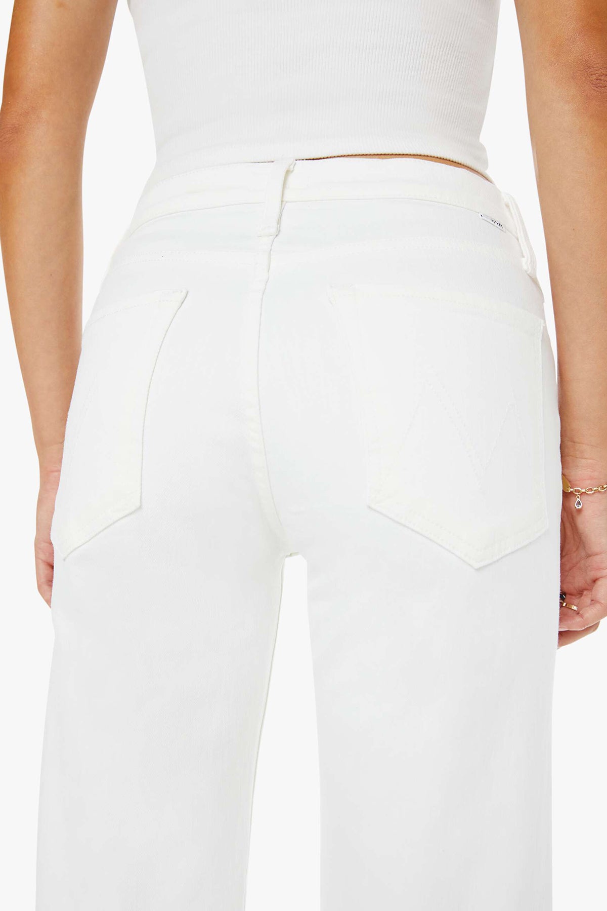 White pants worn by a person with a neutral background