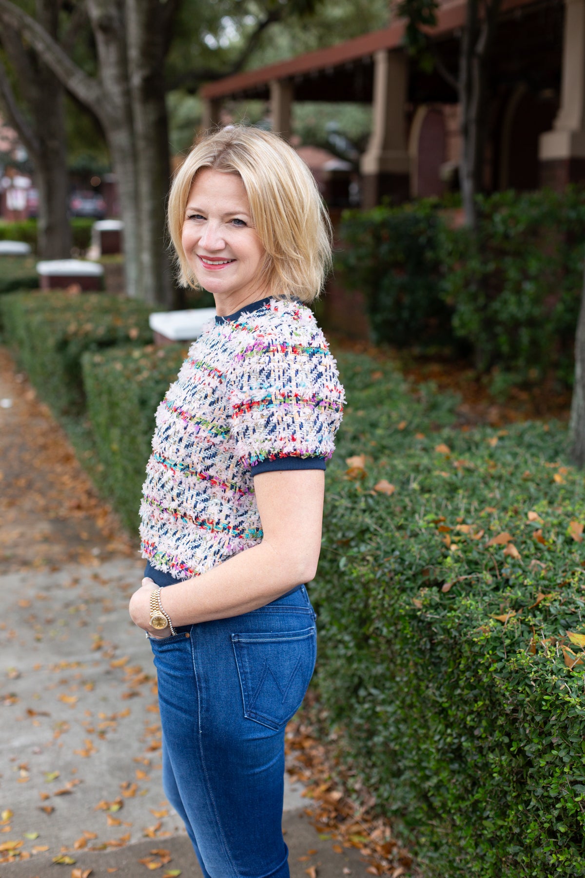 Tweed top with a structured silhouette in neutral tones.