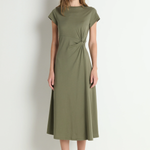 Woman wearing a green dress against a white background