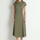 Woman wearing a green dress against a white background