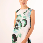 woman in floral printed dress close up on white background 