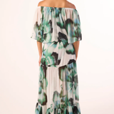 Woman wearing a floral off-shoulder dress on a white background