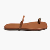 Brown sandal with a single strap on a white background