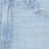 Close-up of light blue denim fabric with stitching details