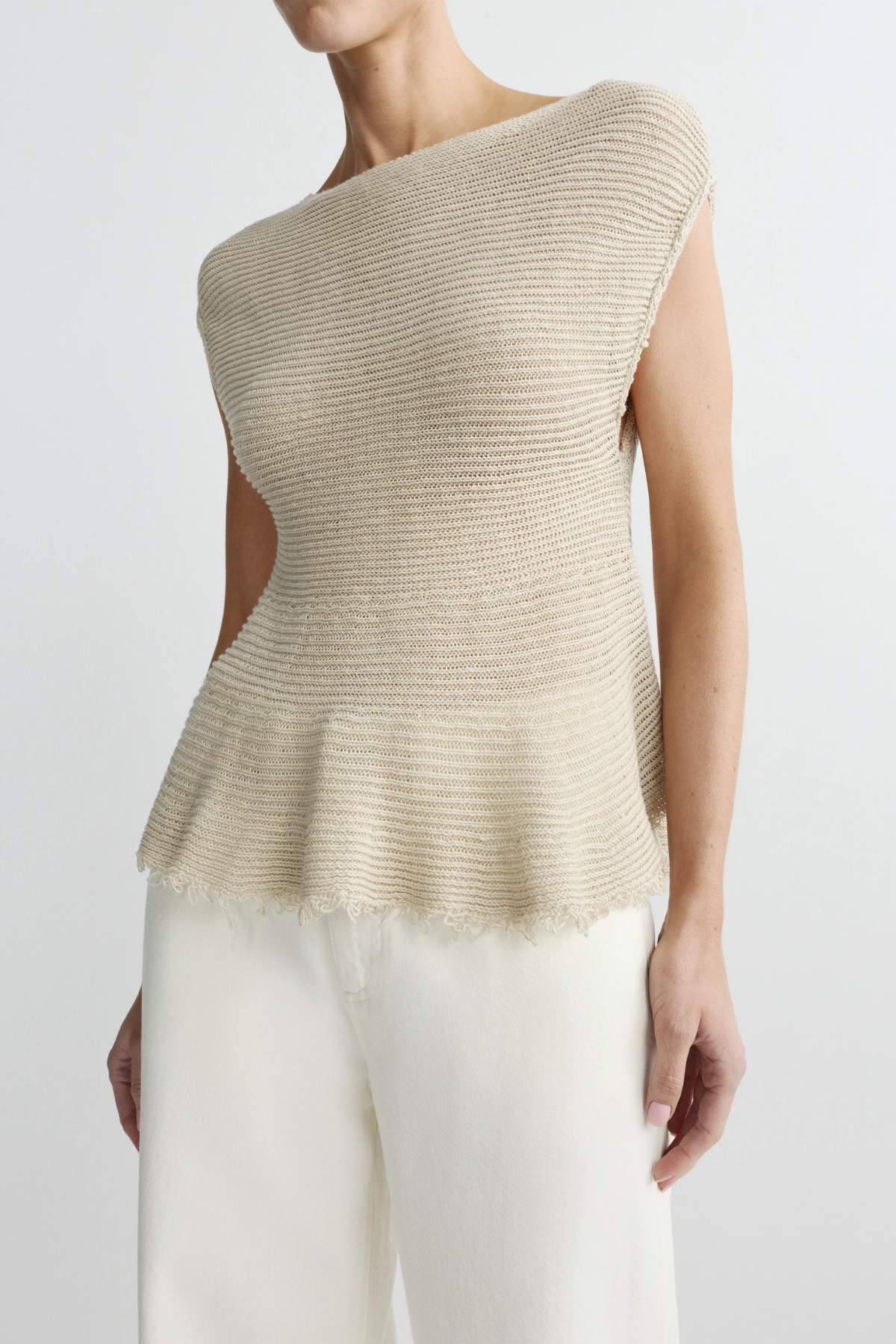 woman in woven tan top on white background 