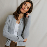woman in grey cardigan on draped background 