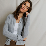 woman in grey cardigan on draped background 