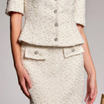 White tweed suit with buttons on a plain background