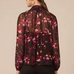 Woman wearing a floral blouse with a beige background