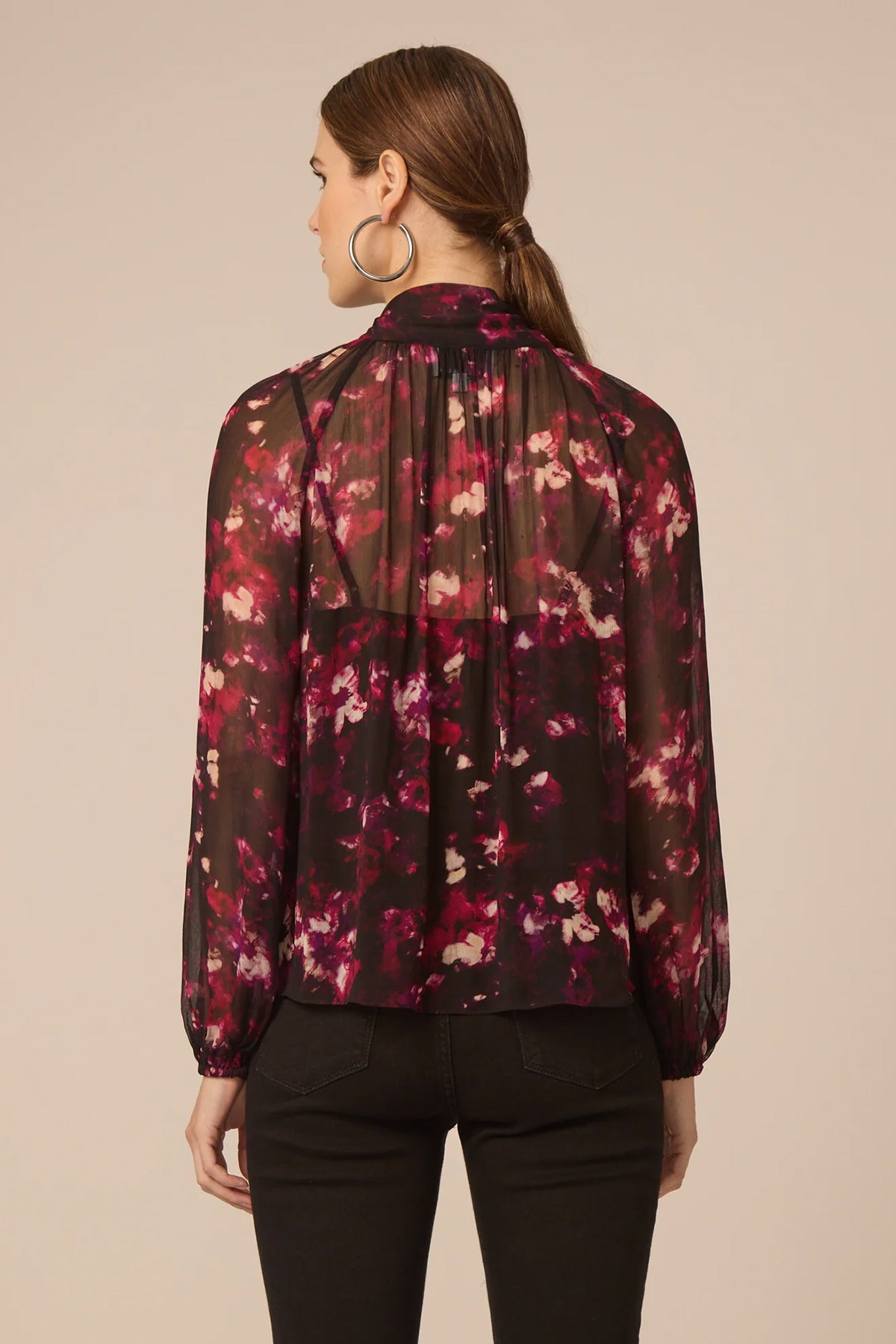 Woman wearing a floral blouse with a beige background