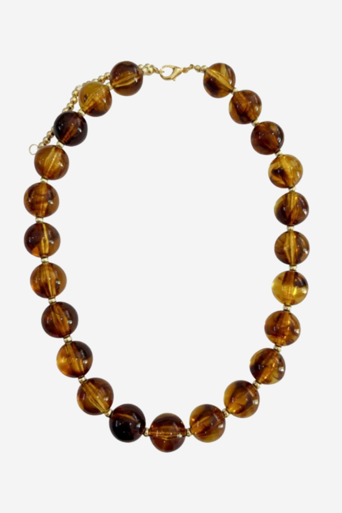 A beaded necklace made of polished round amber-brown glass beads with a small gold clasp, shown on a plain light gray background.