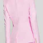 back of woman in pink blazer on white background 